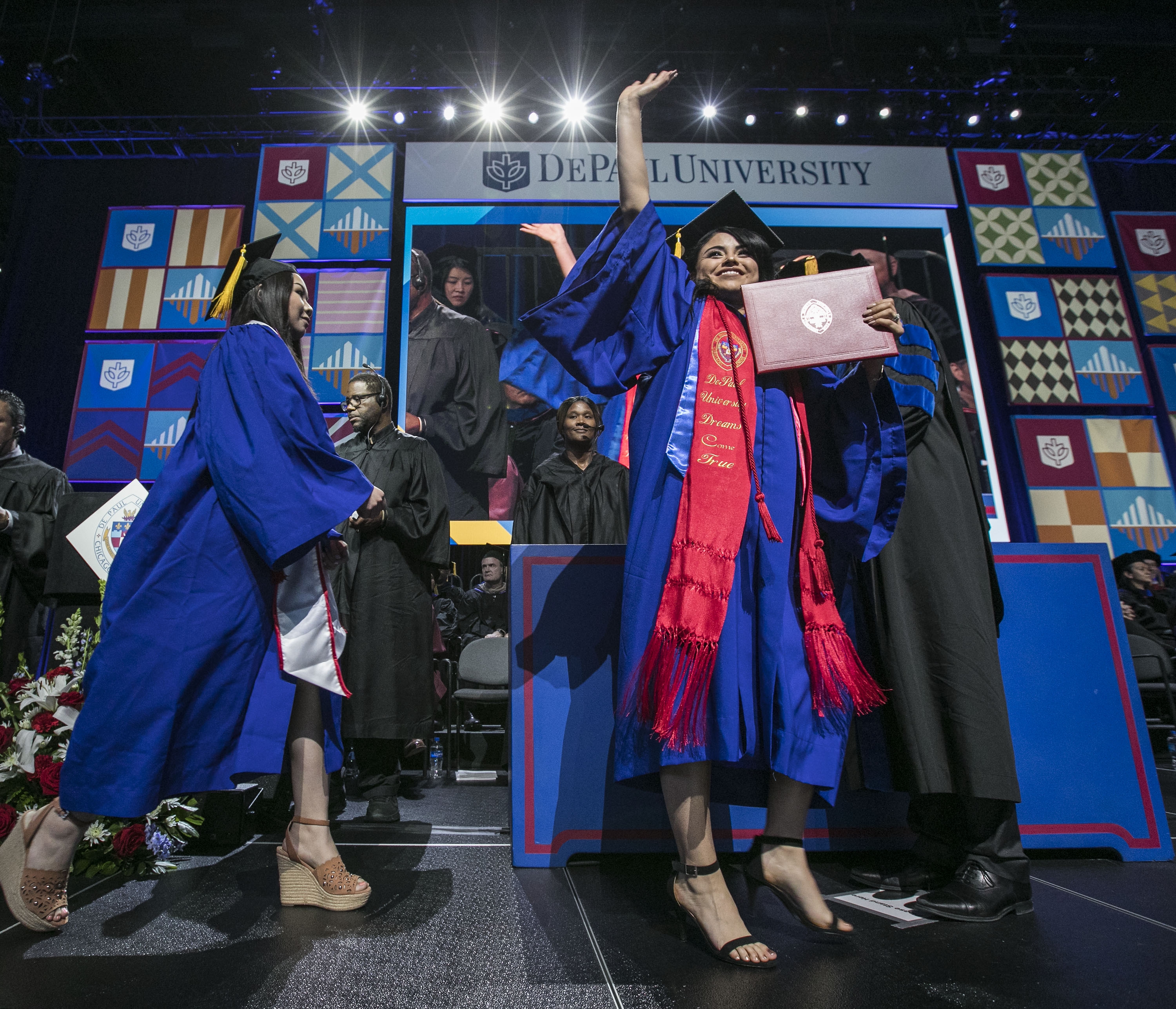 Graduates celebrate as they receive their diplomas during the commencement ceremony for the Driehaus College of Business. (DePaul University/Jamie Moncrief)